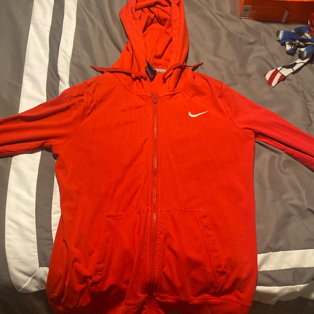 Red Nike jacket, size is medium